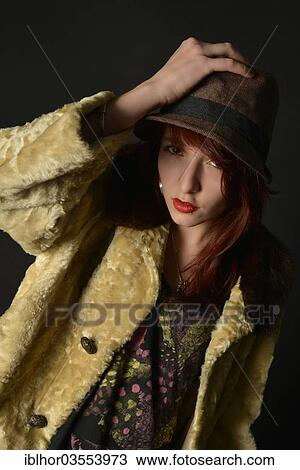 Stock Image - Young woman with hat and coat. Fotosearch