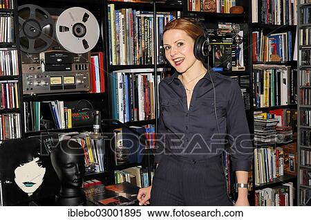 "Young woman with headphones listening to music, Schwabisch Gmund, Baden-Wurttemberg, Germany, Europe" View Large Photo Image Stock Photography - "Young woman with headphones listening to music, Schwabisch Gmund, Baden-Wurttemberg, Germany, Europe". Fotosearch