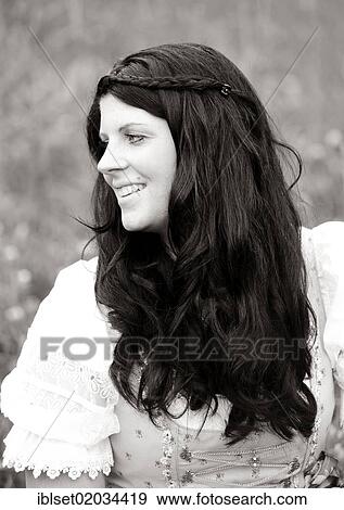 "Young woman with long black hair wearing a dirndl, portrait" View Large Photo Image Stock Photo - "Young woman with long black hair wearing a dirndl, portrait". Fotosearch