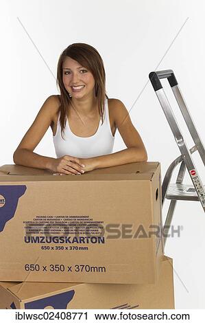 Young woman with moving boxes View Large Photo Image Stock Image - Young woman with moving boxes. Fotosearch