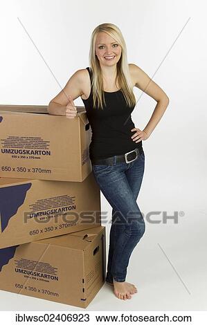 "Young woman with moving boxes, thumbs up" View Large Photo Image Stock Image - "Young woman with moving boxes, thumbs up". Fotosearch
