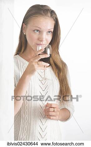 "Young woman with wine glass, looking sad, pensive" View Large Photo Image Picture - "Young woman with wine glass, looking sad, pensive". Fotosearch