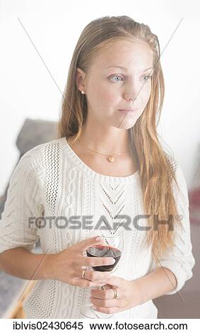 "Young woman with wine glass, looking sad, pensive" View Large Photo Image Stock Photography - "Young woman with wine glass, looking sad, pensive". Fotosearch