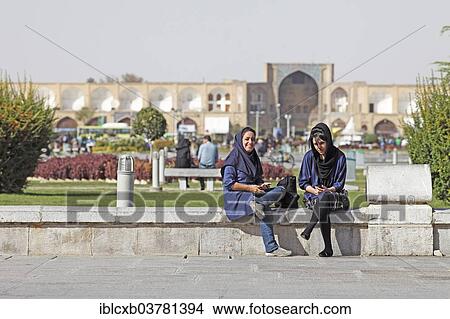 "Young women using a mobile phone in front of the entrance to the Bazaar, Imam Square, Isfahan, Isfahan Province, Persia, Iran, Asia" View Large Photo Image Picture - "Young women using a mobile phone in front of the entrance to the Bazaar, Imam Square, Isfahan, Isfahan Province, Persia, Iran, Asia". Fotosearch