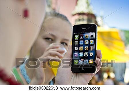 "Young women, woman holding a smartphone in cafe, Freiburg im Breisgau, Baden-Wurttemberg, Germany, Europe" View Large Photo Image Stock Photo - "Young women, woman holding a smartphone in cafe, Freiburg im Breisgau, Baden-Wurttemberg, Germany, Europe". Fotosearch