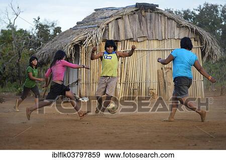 "Youngers of the indigenous Xavante people playing football, village of Tres Rios near Sangradouro, Primavera do Leste, Mato Grosso, Brazil, South America" View Large Photo Image Stock Photo - "Youngers of the indigenous Xavante people playing football, village of Tres Rios near Sangradouro, Primavera do Leste, Mato Grosso, Brazil, South America". Fotosearch