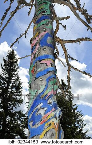 Stock Image - "Zauberbaum tree, painting on a tree by Walter Angerer the Younger, Rauschenberg, Chiemgau Alps, Chiemgau, Upper Bavaria, Bavaria, Germany, Europe, PublicGround, Europe". Fotosearch