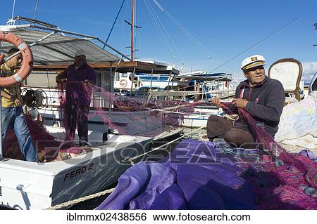 "Zeytineli Koyu, harbour with fishing boats, fishermen repairing a net, Ilica, Izmir Region, Turkey, Asia" View Large Photo Image Stock Photograph - "Zeytineli Koyu, harbour with fishing boats, fishermen repairing a net, Ilica, Izmir Region, Turkey, Asia". Fotosearch