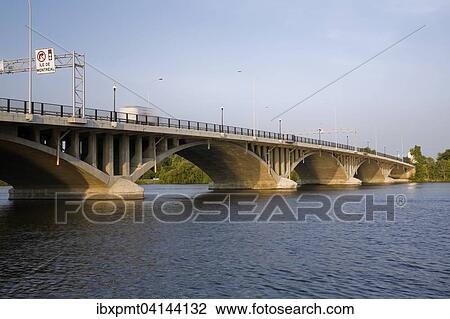 Stock Image - Ahuntsic Bridge, or Viau Bridge, built in 1930, rebuilt in 1962, widened in 1993, spans the Riviere des Prairies between the cities of Laval and Montreal, Quebec, Canada, North America. Fotosearch