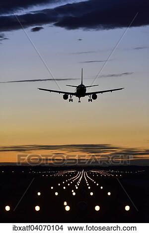Aircraft landing at sunset, Airbus, runway, landing lights, Munich Airport Franz Josef Strauss, Munich, Upper Bavaria, Bavaria, Germany, Europe View Large Photo Image Picture - Aircraft landing at sunset, Airbus, runway, landing lights, Munich Airport Franz Josef Strauss, Munich, Upper Bavaria, Bavaria, Germany, Europe. Fotosearch