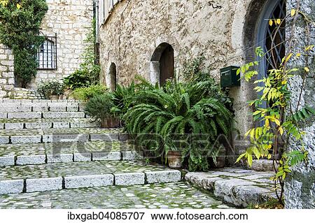 Stock Photo - Alleyway with steps in the medieval city of Saint-Paul or Saint-Paul-de-Vence, Alpes-Maritimes, Provence-Alpes-Cote d'Azur, France, Europe. Fotosearch