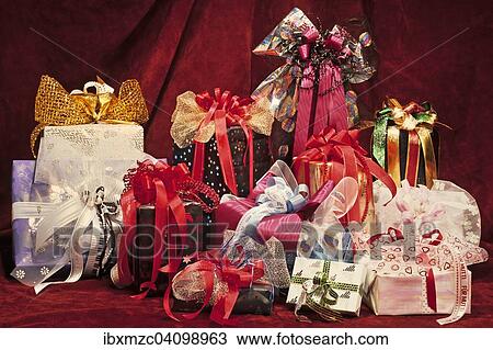 Artfully wrapped gifts, on red fabric View Large Photo Image Stock Image - Artfully wrapped gifts, on red fabric. Fotosearch