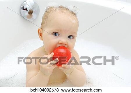 Baby girl, 11 months, while bathing, playing with a ball, Germany, Europe View Large Photo Image Stock Photo - Baby girl, 11 months, while bathing, playing with a ball, Germany, Europe. Fotosearch