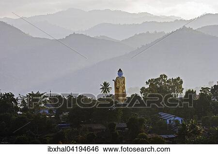 Big Buddha statue against the mountains in the Golden Triangle, Kyaing Tong, Shan State, Myanmar, Asia View Large Photo Image Stock Photograph - Big Buddha statue against the mountains in the Golden Triangle, Kyaing Tong, Shan State, Myanmar, Asia. Fotosearch