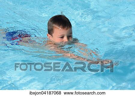 Boy, seven years old, in a swimming school's pool, Ystad, Sweden, Europe View Large Photo Image Stock Photo - Boy, seven years old, in a swimming school's pool, Ystad, Sweden, Europe. Fotosearch