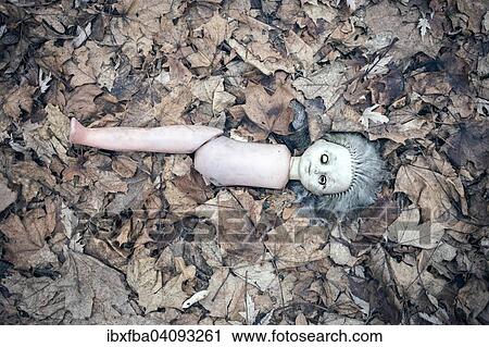 Stock Image - Broken doll lying in the front garden of an abandoned kindergarten, village in the contaminated zone around Chernobyl, Kopachi, Chernobyl, Ukraine, Europe. Fotosearch