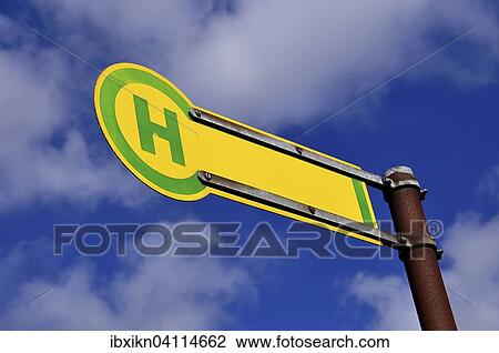Stock Image - Bus stop sign, blue sky, white clouds. Fotosearch
