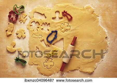Cake dough with a rolling pin and cookie cutters View Large Photo Image Stock Photo - Cake dough with a rolling pin and cookie cutters. Fotosearch