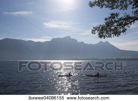 Stock Photography - Canoeists on Lake Mondsee with Drachenwand and Schober, Mondsee, Salzkammergut, Upper Austria, Austria, Europe. Fotosearch