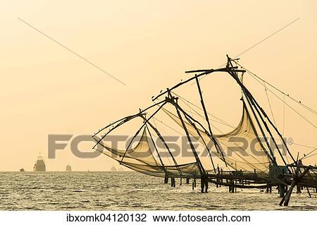 Stock Image - Chinese fishing nets, sunset, Arabian Sea coast, Kochi, Kerala, South India, India, Asia. Fotosearch