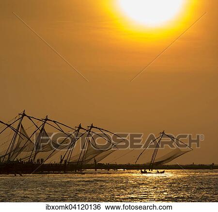 Stock Photograph - Chinese fishing nets, sunset, Arabian Sea coast, Kochi, Kerala, South India, India, Asia. Fotosearch