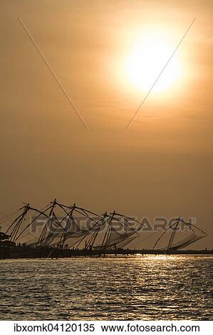 Stock Photography - Chinese fishing nets, sunset, Arabian Sea coast, Kochi, Kerala, South India, India, Asia. Fotosearch