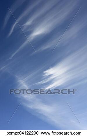 Stock Image - Cirrus clouds in the blue sky. Fotosearch