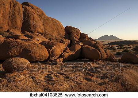 Cliff with rocks at Spitzkoppe, small Spitzkoppe behind, evening light, Namibia, Africa View Large Photo Image Stock Photography - Cliff with rocks at Spitzkoppe, small Spitzkoppe behind, evening light, Namibia, Africa. Fotosearch