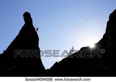Climber on a cliff in the evening light at Savoy Alps, backlit, Chamonix, France, Europe View Large Photo Image Stock Photo - Climber on a cliff in the evening light at Savoy Alps, backlit, Chamonix, France, Europe. Fotosearch