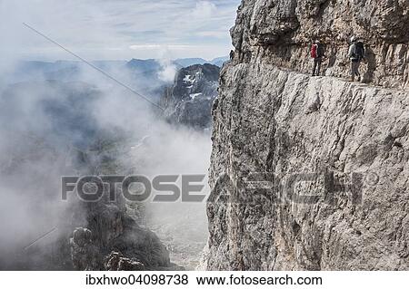 Stock Photo - Climbers on rock band, via ferrata Bocchette Centrali, no. 305, Adamello-Brenta nature park, Brenta group, Dolomites, Trentino, Italy, Europe. Fotosearch