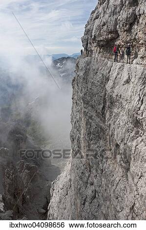 Stock Photograph - Climbers on rock band, via ferrata Bocchette Centrali, no. 305, Adamello-Brenta nature park, Brenta group, Dolomites, Trentino, Italy, Europe. Fotosearch
