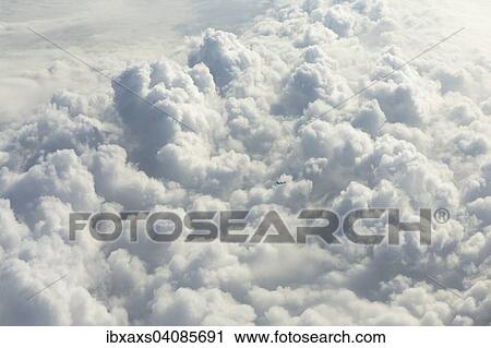 Cloud formations with a small passenger aircraft View Large Photo Image Stock Image - Cloud formations with a small passenger aircraft. Fotosearch