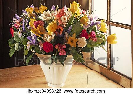 Colourful spring bouquet in a vase in front of a wooden wall by a window View Large Photo Image Stock Photograph - Colourful spring bouquet in a vase in front of a wooden wall by a window. Fotosearch