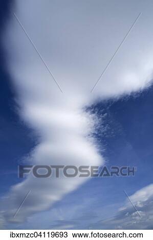 Stock Image - Cumulonimbus capillatus clouds in a blue sky. Fotosearch