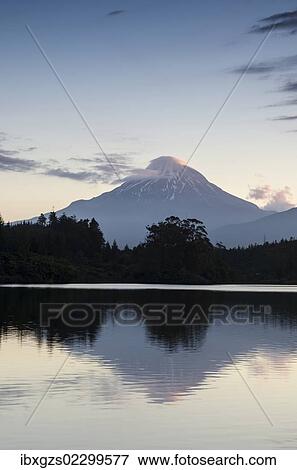 Stock Photo - Currently inactive volcano, Mt. Egmont, Mt. Taranaki, reflection in the reservoir of Lake Mangamahoe, North Island, New Zealand, Oceania. Fotosearch
