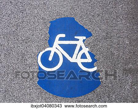 Stock Image - Cycle path marking on a pavement, worn away. Fotosearch