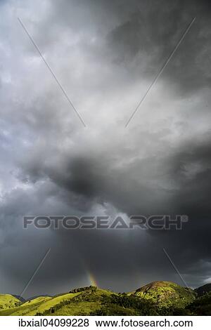 Dark clouds and rainbow above the mountains, Valenca, Rio de Janeiro, Brazil, South America View Large Photo Image Stock Photo - Dark clouds and rainbow above the mountains, Valenca, Rio de Janeiro, Brazil, South America. Fotosearch