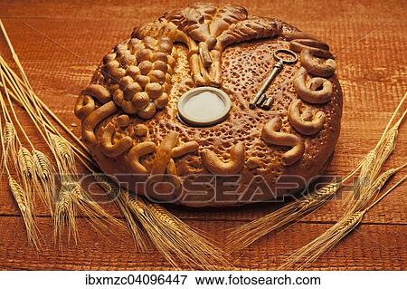 Decorated bread loaf with a key and salt shaker baked into the bread, traditional gift for a house move View Large Photo Image Stock Photo - Decorated bread loaf with a key and salt shaker baked into the bread, traditional gift for a house move. Fotosearch