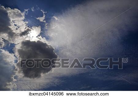 Different cloud formations with sun emerging View Large Photo Image Stock Photograph - Different cloud formations with sun emerging. Fotosearch