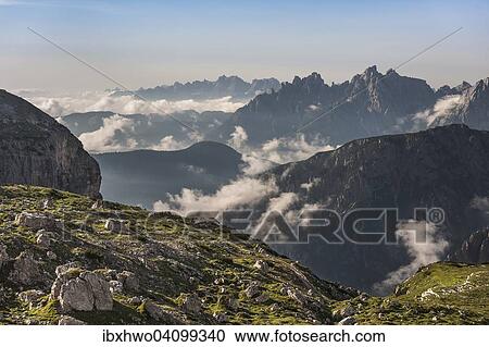 Stock Image - Dolomites panorama, mountain ranges with wafts of mist, evening mood, view from the Tre Cime di Lavaredo area, Dolomites, Veneto, Italy, Europe. Fotosearch