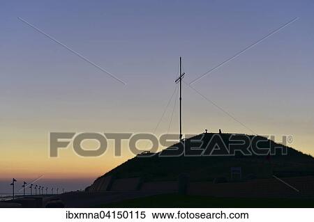 Stock Photography - Dune Georgshohe with summit cross silhouetted in the morning, Norderney, East Frisia, Lower Saxony, Germany, Europe. Fotosearch