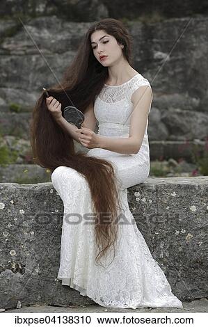Enactment of the painting Lady Lilith by Dante Gabriel Rossetti, young woman in a white dress, combing her hair and looking in the mirror View Large Photo Image Stock Image - Enactment of the painting Lady Lilith by Dante Gabriel Rossetti, young woman in a white dress, combing her hair and looking in the mirror. Fotosearch