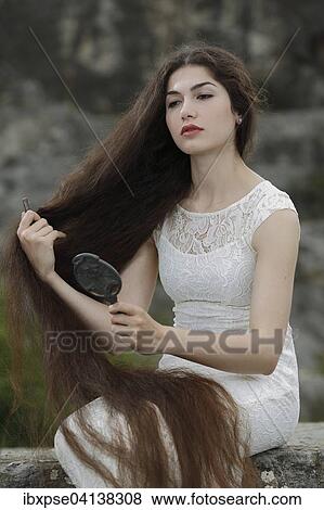 Enactment of the painting Lady Lilith by Dante Gabriel Rossetti, young woman in a white dress, combing her hair and looking in the mirror View Large Photo Image Stock Photo - Enactment of the painting Lady Lilith by Dante Gabriel Rossetti, young woman in a white dress, combing her hair and looking in the mirror. Fotosearch