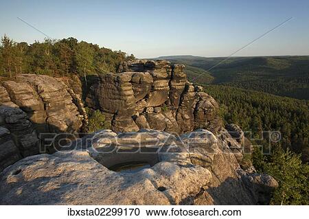 Evening mood from Pfaffenstein table mountain with Opferkessel stone basin in the Elbe Sandstone Mountains, Saxony, Germany, Europe View Large Photo Image Stock Image - Evening mood from Pfaffenstein table mountain with Opferkessel stone basin in the Elbe Sandstone Mountains, Saxony, Germany, Europe. Fotosearch