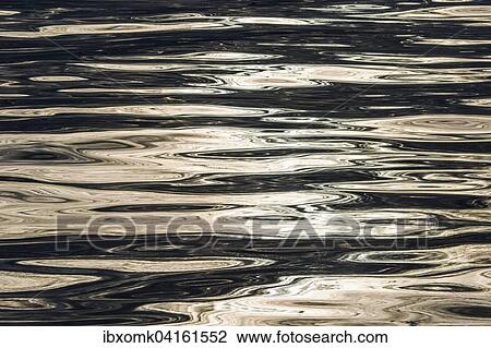 Stock Image - Evening sky and sun reflected on the surface of the sea, Denmark Strait, Greenland, North America. Fotosearch