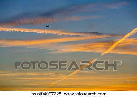 Evening sky, orange contrails, airplane, Dusseldorf, Essen, North Rhine-Westphalia airport, Germany, Europe View Large Photo Image Stock Photography - Evening sky, orange contrails, airplane, Dusseldorf, Essen, North Rhine-Westphalia airport, Germany, Europe. Fotosearch
