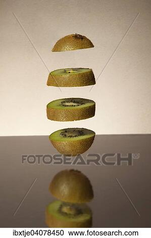 Stock Image - Falling kiwi slices. Fotosearch
