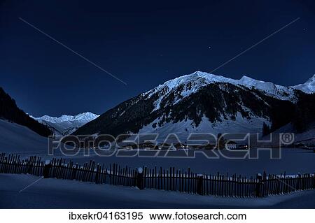 Stock Photography - Farming village at night with starry sky in winter, behind the Tux mountains, Toldern, Schmirntal, Tyrol, Austria, Europe. Fotosearch
