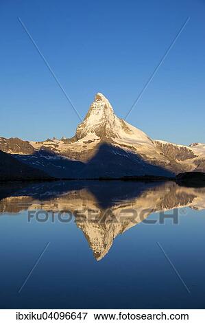 Stock Photo - First sunlight on the Matterhorn with reflection in Stellisee lake, Zermatt, Canton of Valais, Switzerland, Europe. Fotosearch
