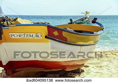 Stock Photo - Fishing boat on the beach, Portimao, Portugal, Europe. Fotosearch